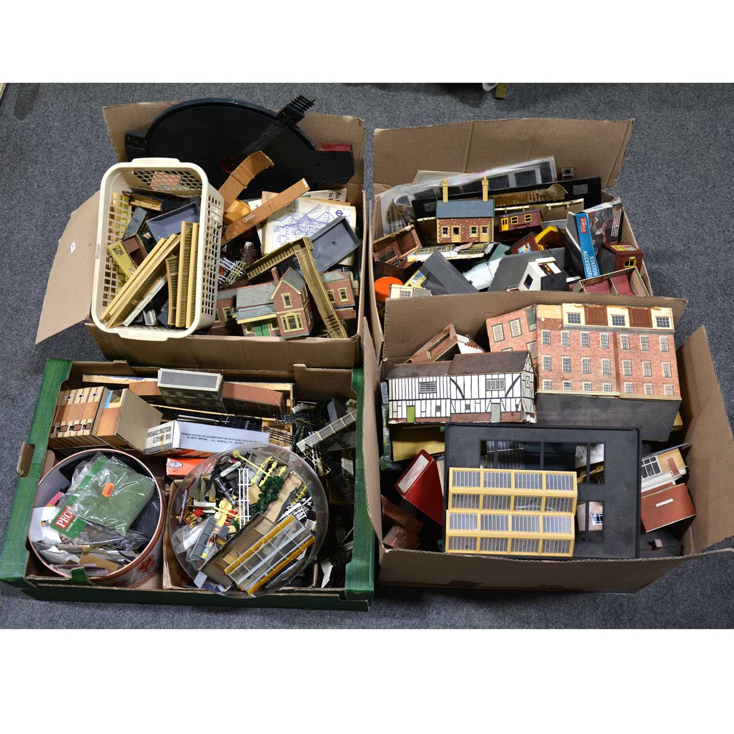 Lot 43 - Four boxes of mostly OO gauge track-side accessories, buildings, scenery and parts.