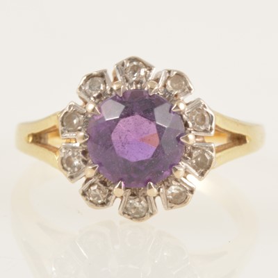 Lot 238 - An amethyst and diamond cluster ring.