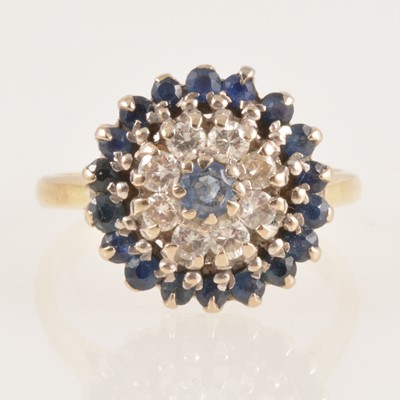 Lot 232 - A sapphire and diamond circular cluster ring.