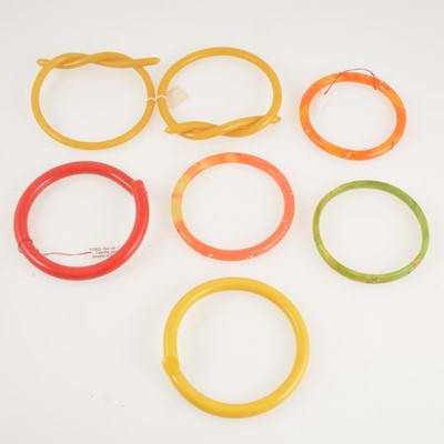 Lot 294 - Seven vintage bakelite and celluloid bangles.