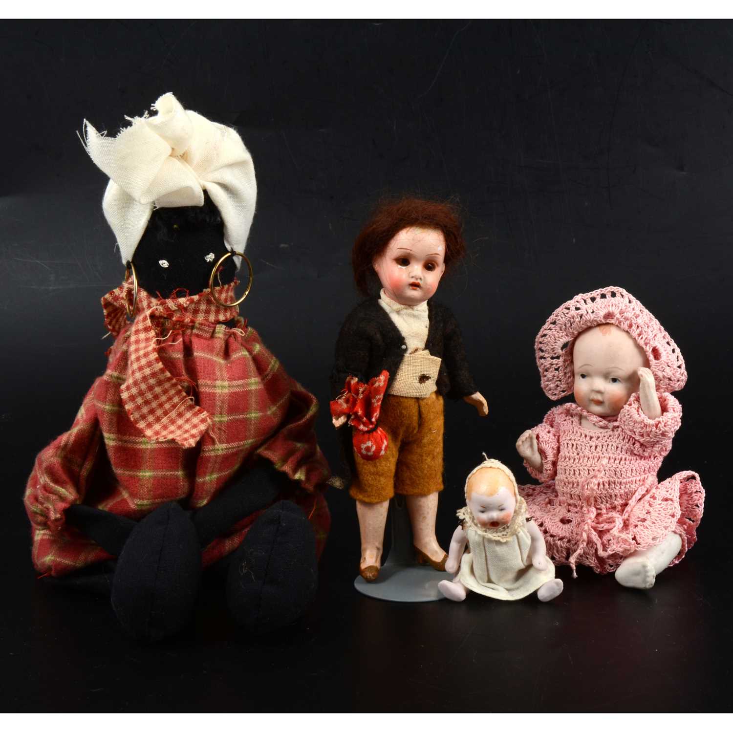 Lot 322 - Four early 20th century small dolls, including tiny all bisque baby doll