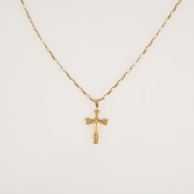 Lot 278 - A yellow metal crucifix pendant on a yellow metal chain.