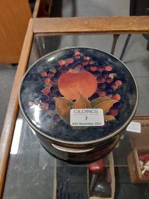 Lot 7 - William Moorcroft 'Pomegranate' pattern drum shaped box, circa 1920