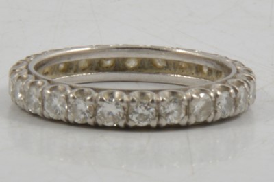 Lot 259 - A diamond full eternity ring.