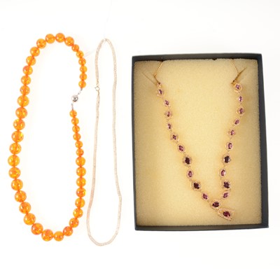 Lot 275 - An amber necklace, gilt necklace and 9 carat necklace with crystals.