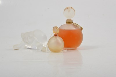 Lot 97 - Lalique - a frosted glass model of a playful kitten, two perfume bottles.