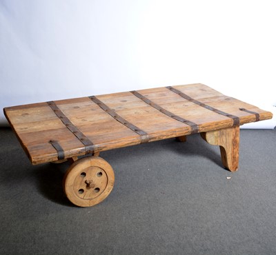 Lot 446 - A modern barn door conversion coffee table with prop and wheel supports.