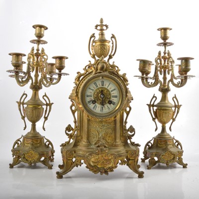 Lot 173 - A three piece French style brass clock garniture, and candelabra.