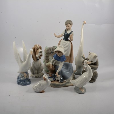 Lot 20 - Nao Girl with Broken Jug, Milk For The Cat, Sad Hound Dog, Panda With Bamboo and four swan figures..