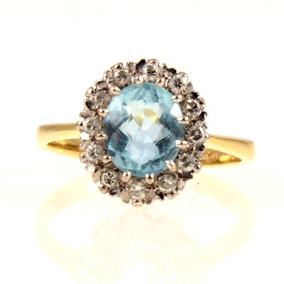 Lot 236 - An aquamarine and diamond oval cluster ring.