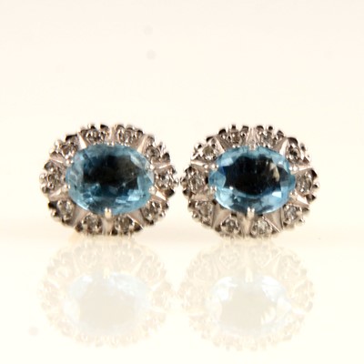 Lot 237 - A pair of aquamarine and diamond oval cluster earrings.