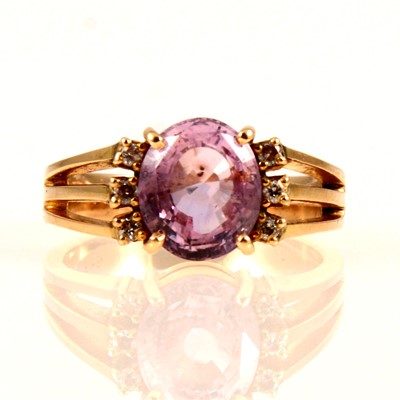 Lot 235 - A synthetic pink sapphire and diamond ring.