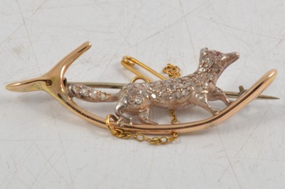 Lot 286 - A diamond set  running fox brooch.