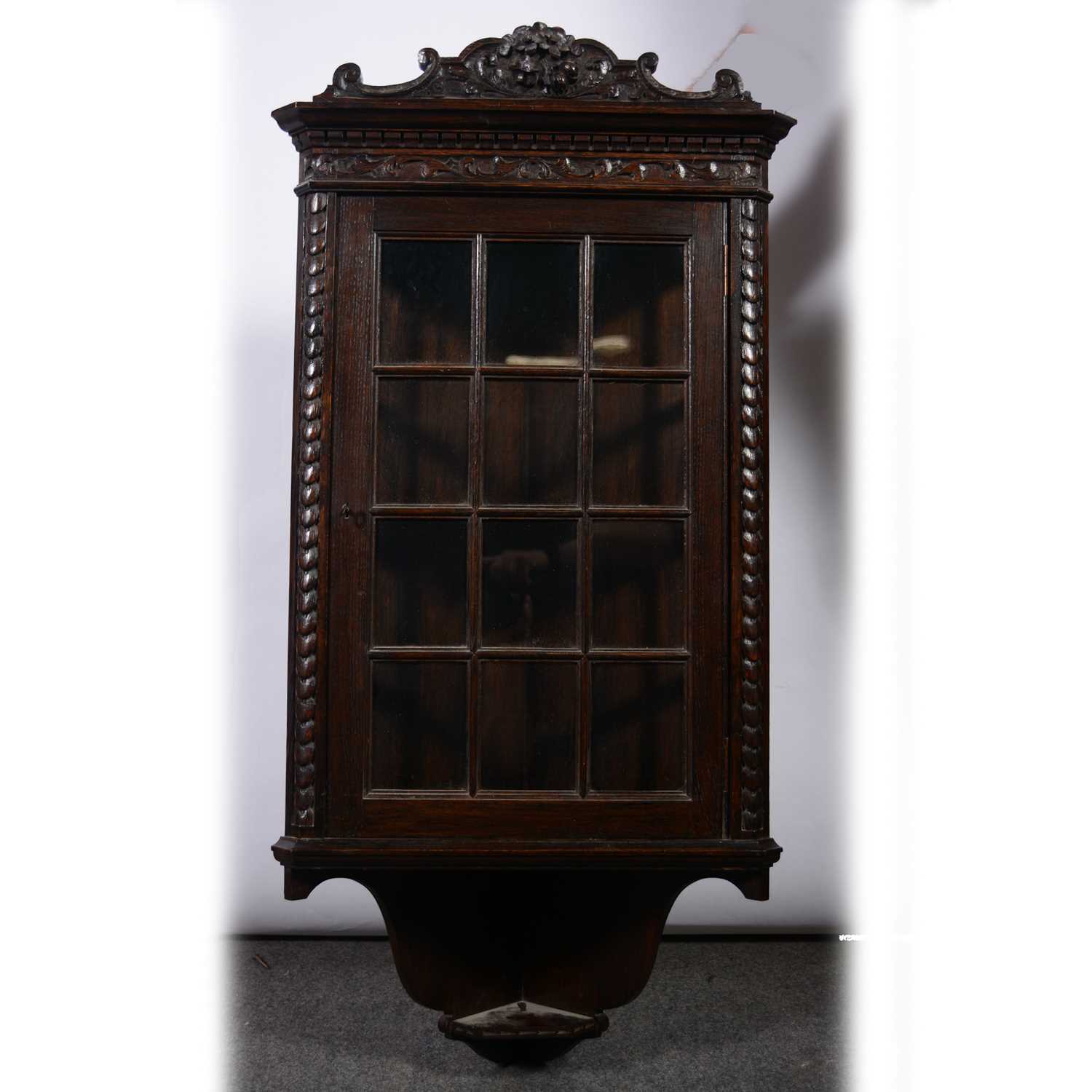 Lot 490 - Small carved oak hanging corner cupboard