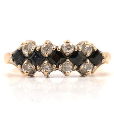 Lot 40 - A sapphire and synthetic white stone ring.
