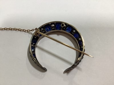 Lot 88 - A sapphire and diamond closed crescent brooch.