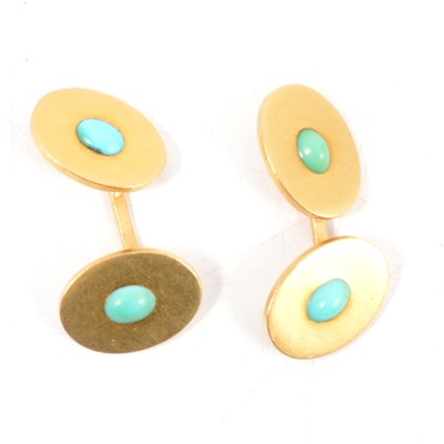 Lot 186 - A pair of cufflinks set with oval cabochon cut turquoise.