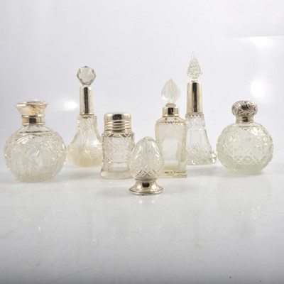 Lot 231 - UPDATED - A silver-bottomed pepperette and six silver-topped / collared cut glass scent bottles.