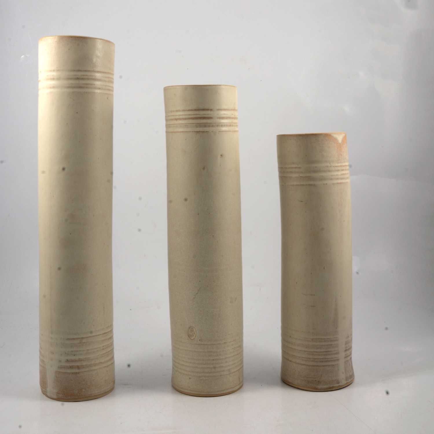 Lot 25 - Three studio pottery cylindrical vases.