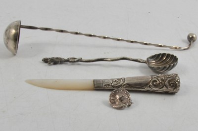 Lot 249 - Mother-of pearl letter opener with silver handle, London 1916, a silver brooch and two white metal spoons.