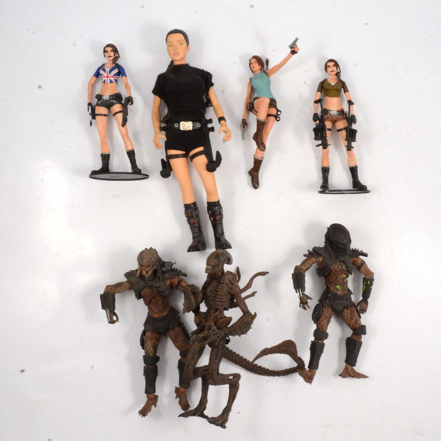 Lot 153 - Three Laura Croft figures and three Alien / Predator figures.
