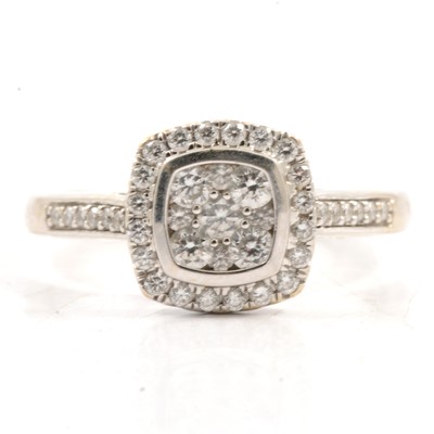 Lot 310 - A diamond halo ring with diamond shoulders.