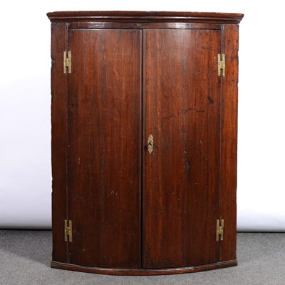 Lot 384 - George III oak hanging corner cupboard