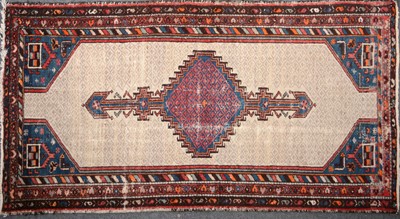 Lot 573 - A Persian rug, red and blue central stepped medallion on a pole