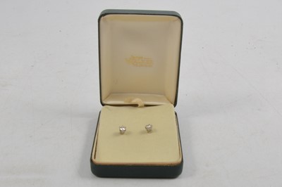 Lot 277 - A pair of diamond solitaire earstuds.