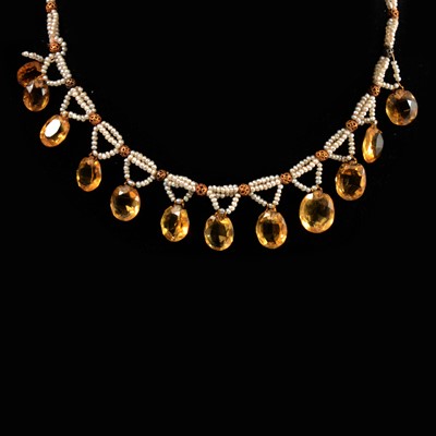 Lot 106 - A seed pearl necklace set with citrines, in need of repair, with magazine article