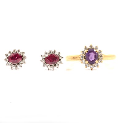 Lot 318 - An amethyst ring and pair of ruby earrings, both set with cubic zirconia.