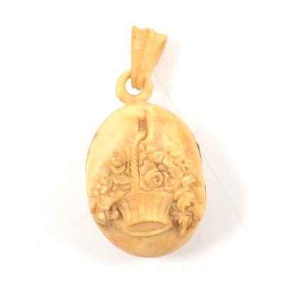 Lot 179A - An ivory locket carved with a basket of flowers, photograph of Stephen Edgar Bundy the artist.