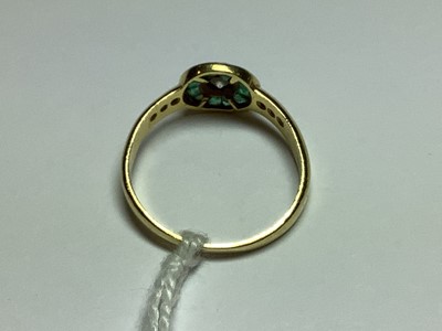 Lot 38 - An emerald and diamond cluster ring.