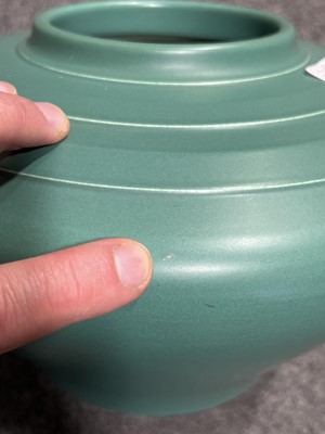 Lot 1051 - Keith Murray for Wedgwood, a squat vase in matt green glaze