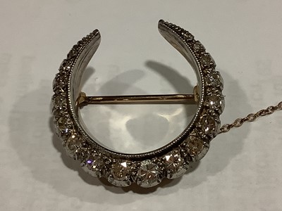 Lot 150 - A diamond closed crescent brooch.