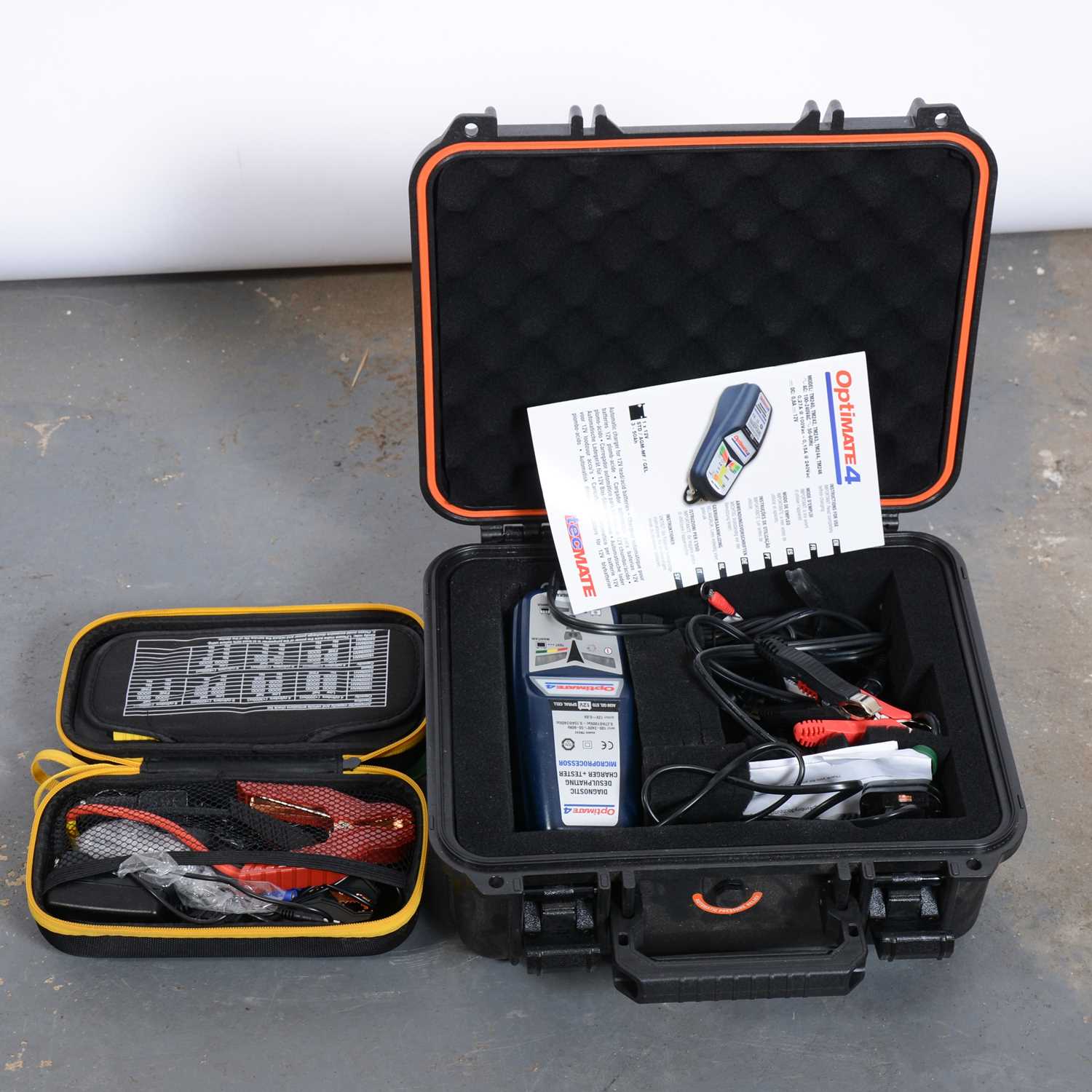 Lot 261 - A box of car accessories including a emergency starter kit and a Optimate smart charger kit.
