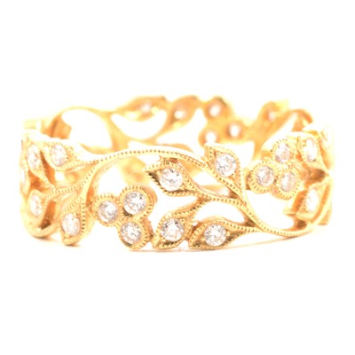 Lot 22 - A diamond set 18 carat yellow gold filigree band.