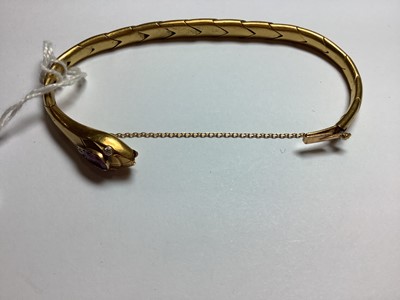 Lot 101 - A ruby and diamond snake design bracelet.