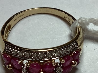 Lot 27 - A ruby and diamond domed ring..