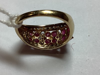 Lot 27 - A ruby and diamond domed ring..
