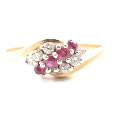 Lot 29 - A ruby and diamond crossover ring.
