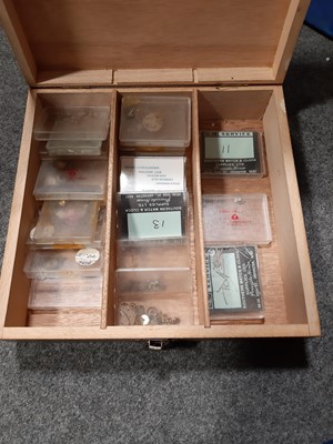Lot 122 - Plastic crate and wooden four drawer chest of small watch parts