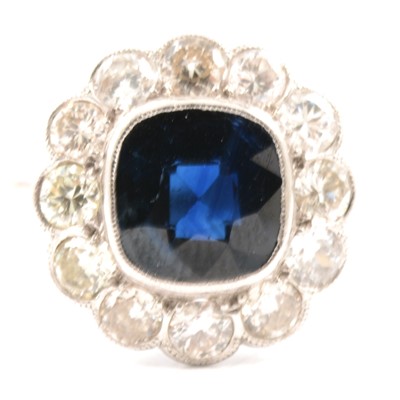 Lot 31 - A sapphire and diamond cluster ring.