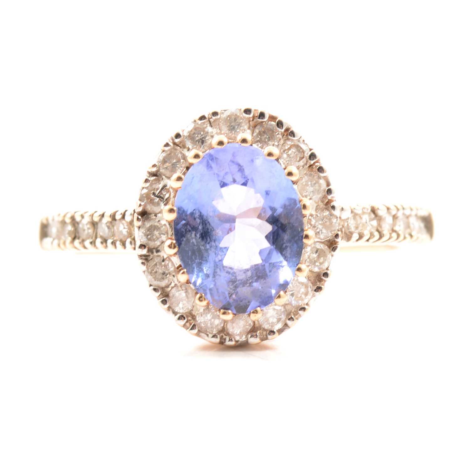 Lot 33 - A tanzanite and diamond cluster ring.