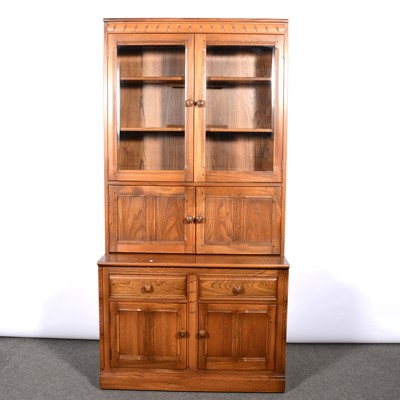 Lot 374 - Ercol, three bookcases/ display cabinets