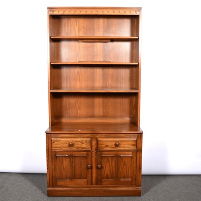 Lot 374 - Ercol, three bookcases/ display cabinets