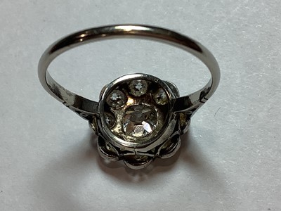 Lot 18 - A nine stone diamond cluster ring.