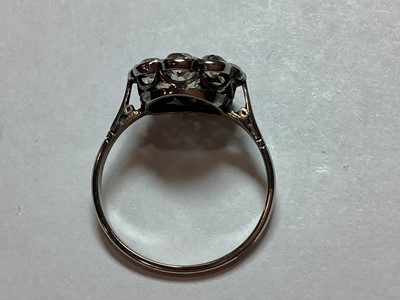 Lot 18 - A nine stone diamond cluster ring.