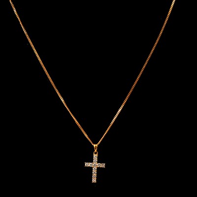 Lot 121 - An 18 carat gold diamond set cross and chain, new and boxed.