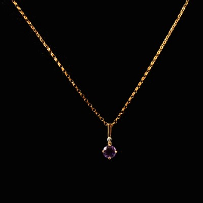 Lot 128 - An amethyst pendant and chain in 9 carat gold, new and boxed.